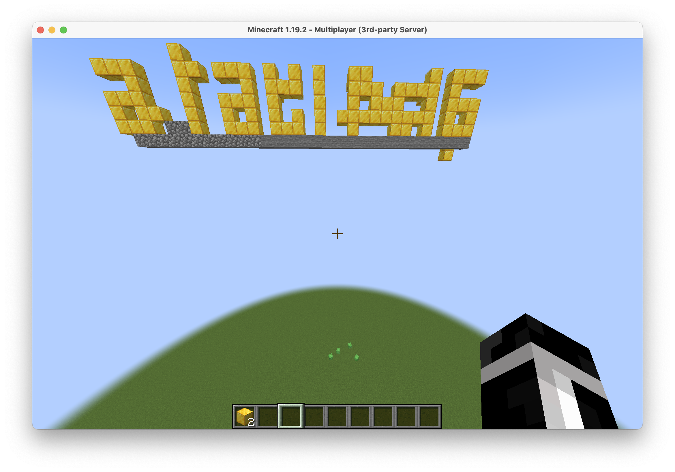 screenshot of minecraft, showing garbled text spelled out with gold blocks